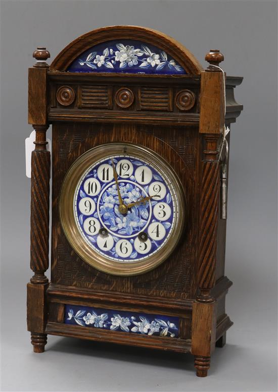 A Victorian oak mantel clock inset blue and white panels height 33c,